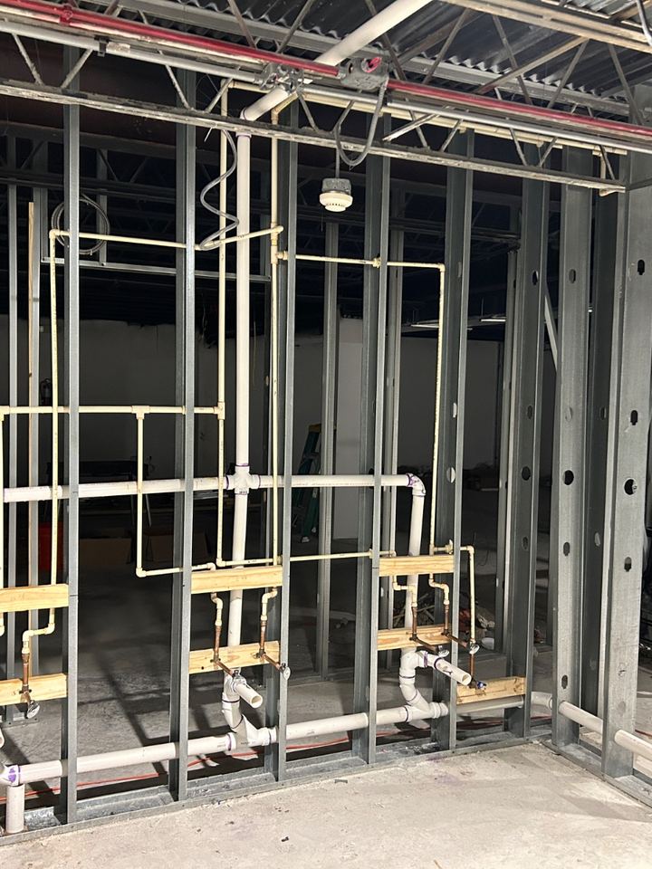 Tight rough-in plumbing run on commercial steel framing